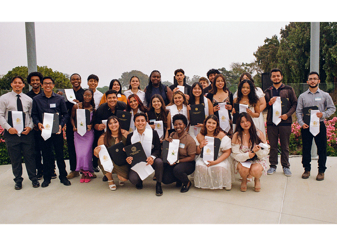 photo of a large group of people posing for a graduation